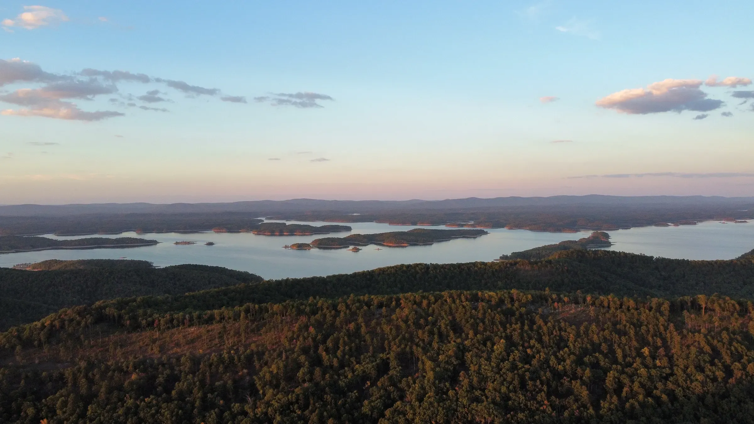 Aerial view of Lake Ouachita's islands and forested ridges at sunset